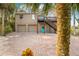 Two-story house with a brick driveway and palm trees at 8711 Betty St, Port Richey, FL 34668