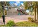 Two-story house with double garage, charming front porch, and brick driveway at 8711 Betty St, Port Richey, FL 34668