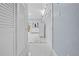 Light and bright hallway with white doors and marble flooring at 8711 Betty St, Port Richey, FL 34668