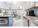 Island kitchen with granite countertops and modern appliances at 8711 Betty St, Port Richey, FL 34668