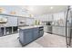 Modern kitchen with large island, stainless steel appliances and wine cooler at 8711 Betty St, Port Richey, FL 34668
