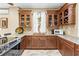 Modern kitchen with wood cabinets, granite counters, and copper sink at 8711 Betty St, Port Richey, FL 34668