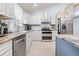 Updated kitchen featuring stainless steel appliances and granite countertops at 8711 Betty St, Port Richey, FL 34668