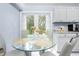 Kitchen breakfast nook with glass table and view to backyard at 8711 Betty St, Port Richey, FL 34668