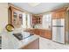 Modern kitchen with granite counters, wood cabinets, and a copper sink at 8711 Betty St, Port Richey, FL 34668