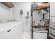 Laundry room with washer, dryer, and storage shelves at 8711 Betty St, Port Richey, FL 34668