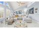 Bright living room with vaulted ceilings, a large sectional sofa, and a marble floor at 8711 Betty St, Port Richey, FL 34668