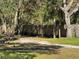 Fenced side yard with mature trees at 9741 Star Trl, New Port Richey, FL 34654