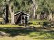 Brown wooden storage shed in backyard at 9741 Star Trl, New Port Richey, FL 34654