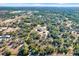 Aerial view of a house on a large lot with surrounding woodland at 10030 Orchard Way, Spring Hill, FL 34608