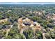 Aerial view showing home, pool, and large lot with surrounding trees at 10030 Orchard Way, Spring Hill, FL 34608