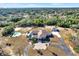 Aerial view of a home with pool, detached garage, and expansive lot at 10030 Orchard Way, Spring Hill, FL 34608