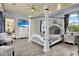 Main bedroom with a large four poster bed and plenty of natural light at 10030 Orchard Way, Spring Hill, FL 34608