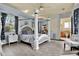 Main bedroom with a large four-poster bed and ensuite bathroom at 10030 Orchard Way, Spring Hill, FL 34608
