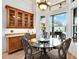 Charming breakfast nook with glass table and view of backyard at 10030 Orchard Way, Spring Hill, FL 34608