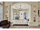 Bright entryway with tile floors, decorative columns and a view into the living room at 10030 Orchard Way, Spring Hill, FL 34608
