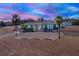 Stunning curb appeal of a two-story home at dusk at 10030 Orchard Way, Spring Hill, FL 34608