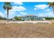 House exterior showcasing landscaping and a large driveway at 10030 Orchard Way, Spring Hill, FL 34608