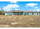 Back of house showing screened patio and yard at 10030 Orchard Way, Spring Hill, FL 34608