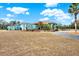 Landscaped grounds and a teal house at 10030 Orchard Way, Spring Hill, FL 34608