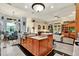 Open concept kitchen with island, breakfast nook, and living room view at 10030 Orchard Way, Spring Hill, FL 34608