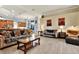 Spacious living room with a view of the kitchen and a cozy sitting area at 10030 Orchard Way, Spring Hill, FL 34608