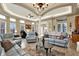 Spacious living area with comfortable seating and a large TV at 10030 Orchard Way, Spring Hill, FL 34608
