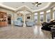 Spacious living room featuring a vaulted ceiling, tile floors and ample seating at 10030 Orchard Way, Spring Hill, FL 34608