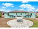 Outdoor kitchen area with built-in seating and fire pit at 10030 Orchard Way, Spring Hill, FL 34608