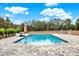 Relaxing pool area with patio furniture and umbrella at 10030 Orchard Way, Spring Hill, FL 34608