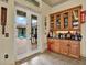 Wet bar with glass-front cabinetry and a view of the backyard at 10030 Orchard Way, Spring Hill, FL 34608