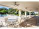 Covered patio with tables and chairs overlooking the pool area at 10135 Zennia Ln, Parrish, FL 34219