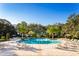 Large community pool surrounded by comfortable lounge chairs at 10135 Zennia Ln, Parrish, FL 34219