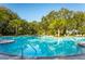 Inviting community pool with ample lounge chairs and lush landscaping at 10135 Zennia Ln, Parrish, FL 34219