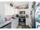 Small kitchen with white cabinets and stainless steel appliances at 10147 Spring Hill Dr, Spring Hill, FL 34608