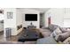 Living room features gray couch, large TV, and wood-look floors at 10147 Spring Hill Dr, Spring Hill, FL 34608
