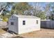 White metal storage shed with two windows in backyard at 10147 Spring Hill Dr, Spring Hill, FL 34608