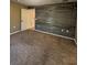 Bedroom with wood-look accent wall and carpet at 10176 Foley St, Brooksville, FL 34601