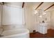 Bathroom with shower/tub combo and pedestal sink at 106 Banana St, Tarpon Springs, FL 34689