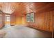 Spacious bedroom with wood walls and floors, offering ample natural light at 106 Banana St, Tarpon Springs, FL 34689