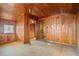 Bright bedroom with wood walls and floors and access to another room at 106 Banana St, Tarpon Springs, FL 34689