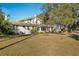 Back of house showing expansive yard, mature trees and boat at 106 Banana St, Tarpon Springs, FL 34689