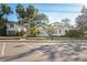Street view of a white house with green roof and adjacent garage at 106 Banana St, Tarpon Springs, FL 34689