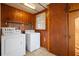 Laundry room with washer, dryer, and built-in cabinets at 106 Banana St, Tarpon Springs, FL 34689