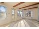 Sunroom featuring wood beams, tile floors, and ample natural light at 106 Banana St, Tarpon Springs, FL 34689