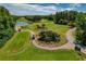 Aerial view of a lush golf course with picturesque fairways and greens at 1082 Dartford Dr, Tarpon Springs, FL 34688