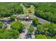 Aerial view of the clubhouse, golf course and wooded surroundings at 1082 Dartford Dr, Tarpon Springs, FL 34688