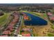 Community aerial view showcasing tranquil water and golf views, with well-maintained landscaping and a community pool at 1082 Dartford Dr, Tarpon Springs, FL 34688