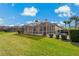 Spacious backyard with a screened-in pool and patio seating area at 1082 Dartford Dr, Tarpon Springs, FL 34688