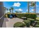 Backyard featuring a patio, lush landscaping, and serene pond views at 1082 Dartford Dr, Tarpon Springs, FL 34688